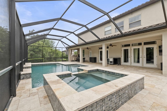 view of swimming pool featuring a patio, a pool with connected hot tub, french doors, and a ceiling fan