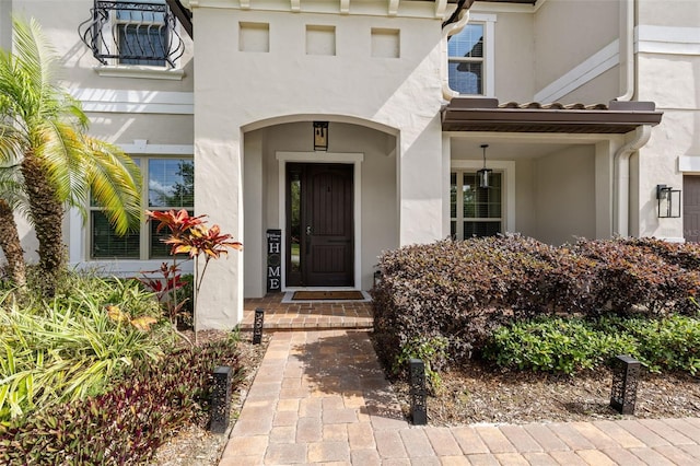 entrance to property with stucco siding
