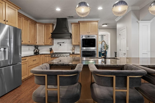 kitchen with dark wood finished floors, ornamental molding, a sink, stainless steel appliances, and premium range hood