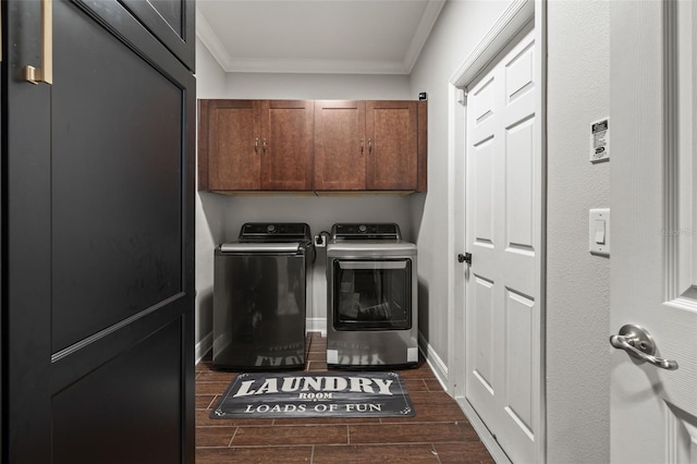 laundry area with baseboards, washer and dryer, ornamental molding, wood tiled floor, and cabinet space