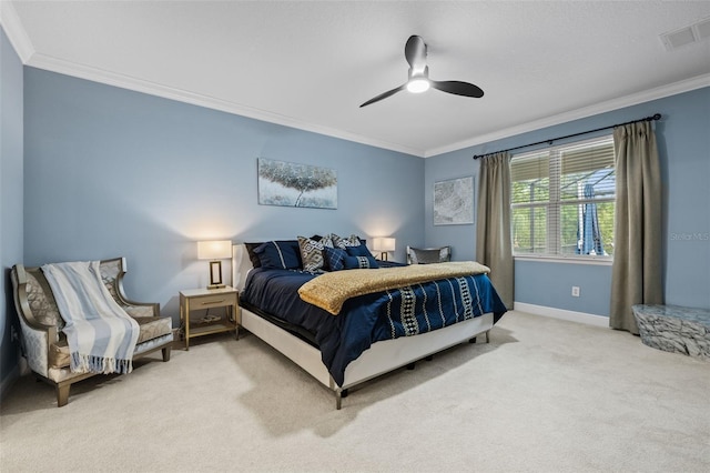 carpeted bedroom with ceiling fan, baseboards, ornamental molding, and visible vents