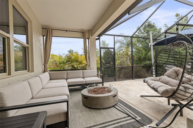 sunroom with an outdoor living space with a fire pit