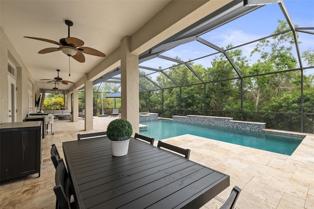 view of swimming pool featuring ceiling fan, a pool with connected hot tub, outdoor lounge area, a patio, and a lanai