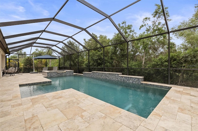 view of swimming pool featuring a patio, a pool with connected hot tub, and glass enclosure