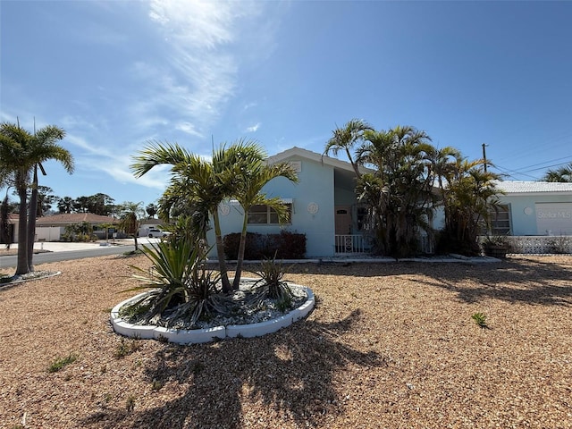 195 45th Ave, St Pete Beach, FL 33706 - view of side of home featuring stucco siding