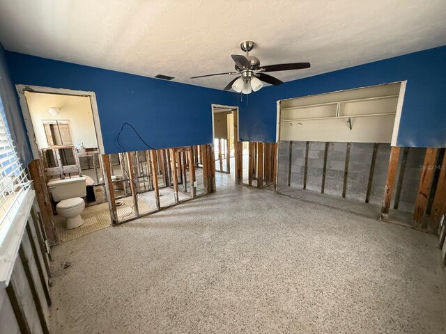 195 45th Ave, St Pete Beach, FL 33706 - unfurnished bedroom with speckle patterned floor, a closet, and a ceiling fan
