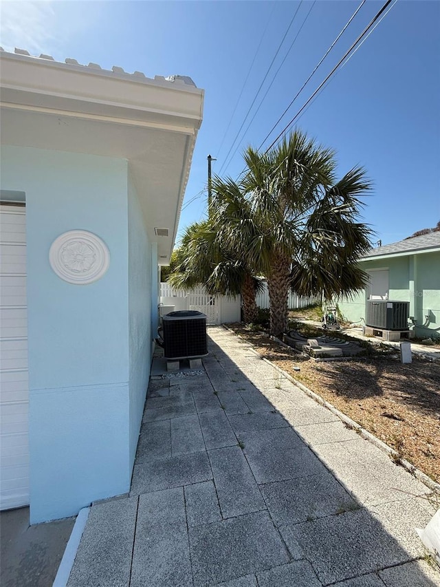 195 45th Ave, St Pete Beach, FL 33706 - view of side of property featuring a cooling unit and a patio area