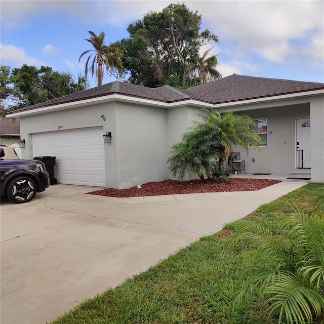 6690 54th Ave N, Saint Petersburg, FL 33709 - view of home's exterior featuring concrete driveway, stucco siding, and an attached garage