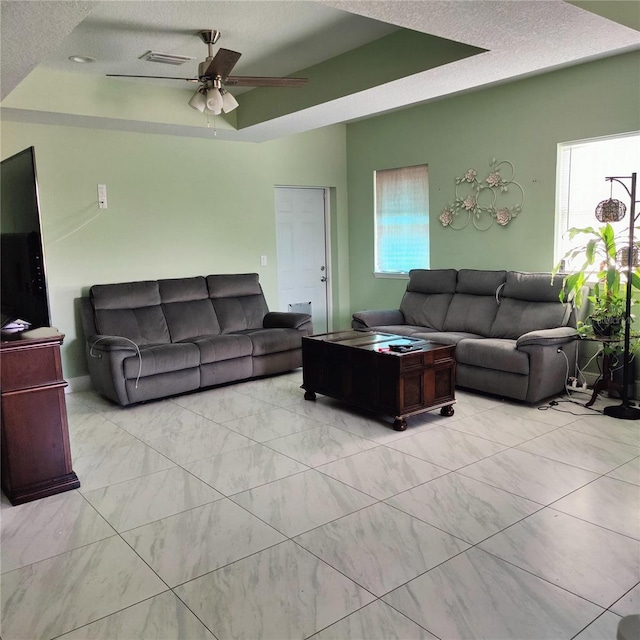 6690 54th Ave N, Saint Petersburg, FL 33709 - living area featuring visible vents, a tray ceiling, a ceiling fan, and a textured ceiling