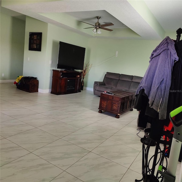 6690 54th Ave N, Saint Petersburg, FL 33709 - living area with a tray ceiling, ceiling fan, and baseboards