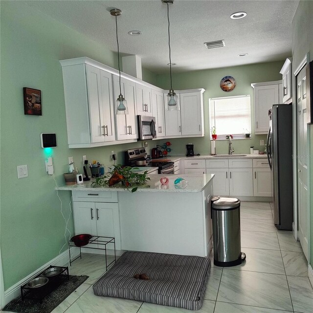 6690 54th Ave N, Saint Petersburg, FL 33709 - kitchen featuring a peninsula, visible vents, appliances with stainless steel finishes, light countertops, and a sink