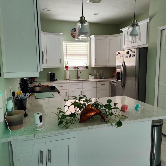 6690 54th Ave N, Saint Petersburg, FL 33709 - kitchen with white cabinets, stainless steel refrigerator with ice dispenser, pendant lighting, and a sink