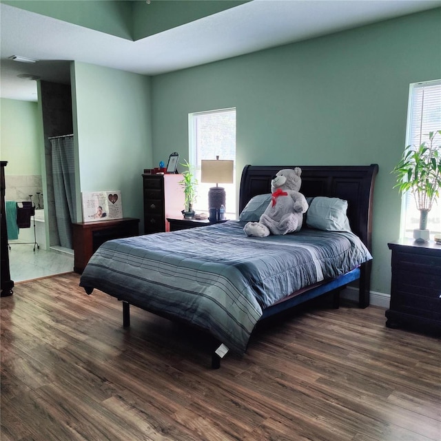 6690 54th Ave N, Saint Petersburg, FL 33709 - bedroom featuring multiple windows and wood finished floors