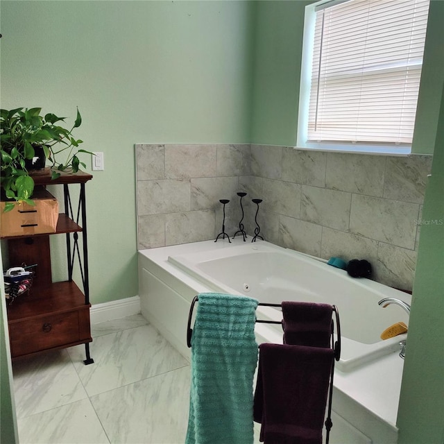 6690 54th Ave N, Saint Petersburg, FL 33709 - bathroom with a bath, marble finish floor, and baseboards