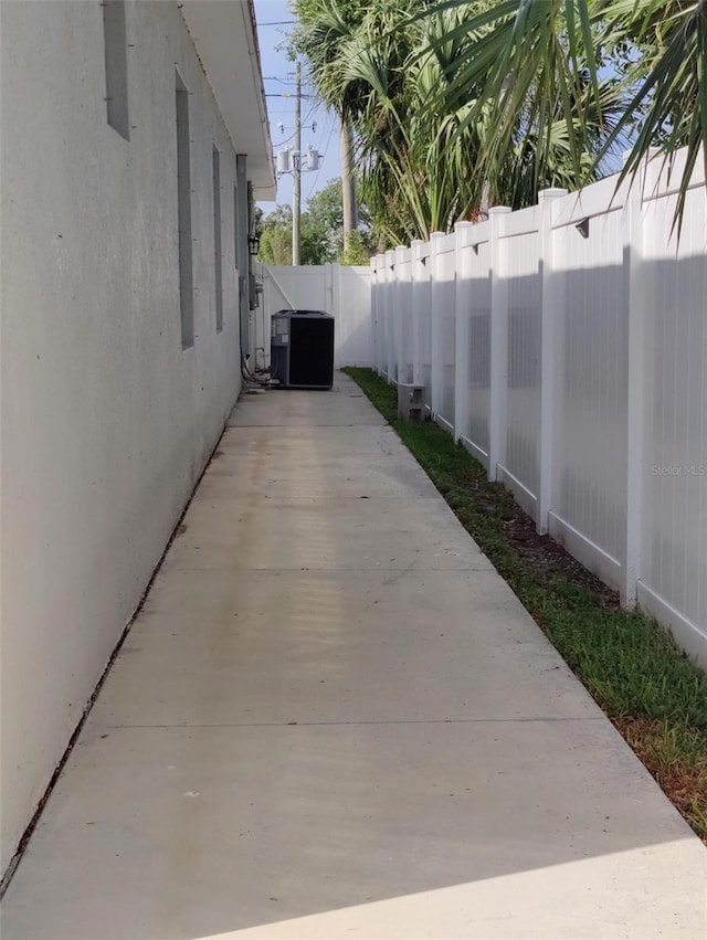 6690 54th Ave N, Saint Petersburg, FL 33709 - view of property exterior featuring central AC unit, a fenced backyard, and stucco siding