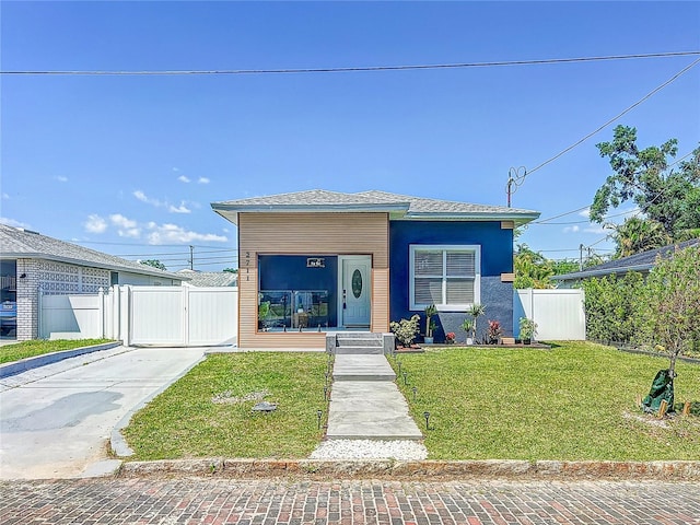 2711 W Cordelia St, Tampa, FL 33607 - view of front of property with a front lawn, fence, a gate, and driveway