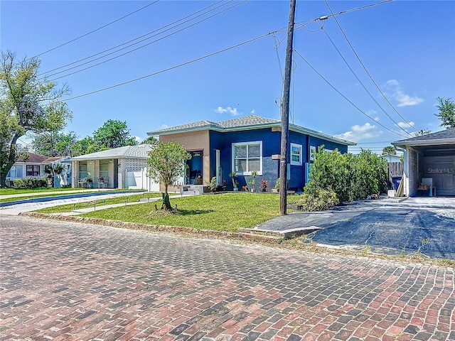 2711 W Cordelia St, Tampa, FL 33607 - single story home featuring a front lawn, driveway, and stucco siding