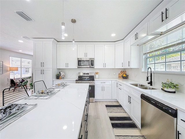 2711 W Cordelia St, Tampa, FL 33607 - kitchen with a healthy amount of sunlight, a sink, visible vents, and stainless steel appliances