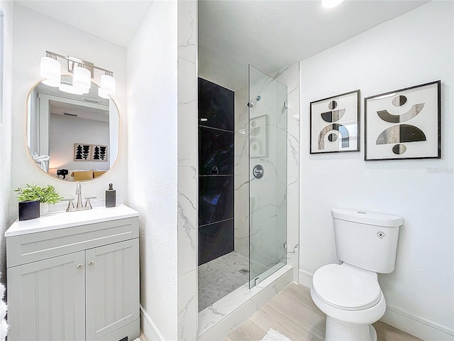 2711 W Cordelia St, Tampa, FL 33607 - full bathroom with vanity, toilet, wood finished floors, a marble finish shower, and baseboards