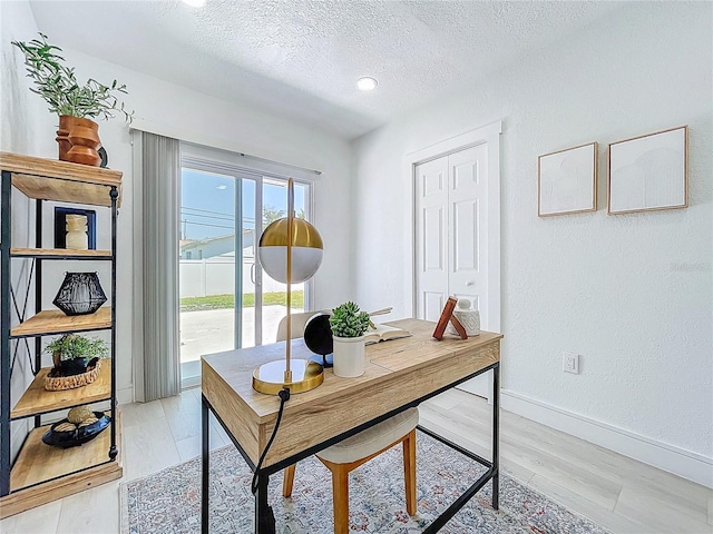 2711 W Cordelia St, Tampa, FL 33607 - office space featuring light wood-style flooring, a textured ceiling, and baseboards