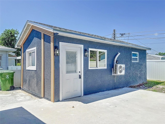 2711 W Cordelia St, Tampa, FL 33607 - view of front of property with a patio, stucco siding, fence, and ac unit