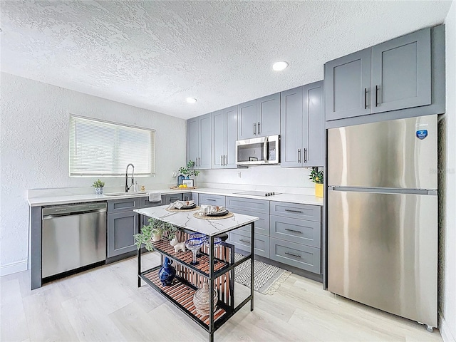 2711 W Cordelia St, Tampa, FL 33607 - kitchen with gray cabinets, light countertops, a sink, and appliances with stainless steel finishes