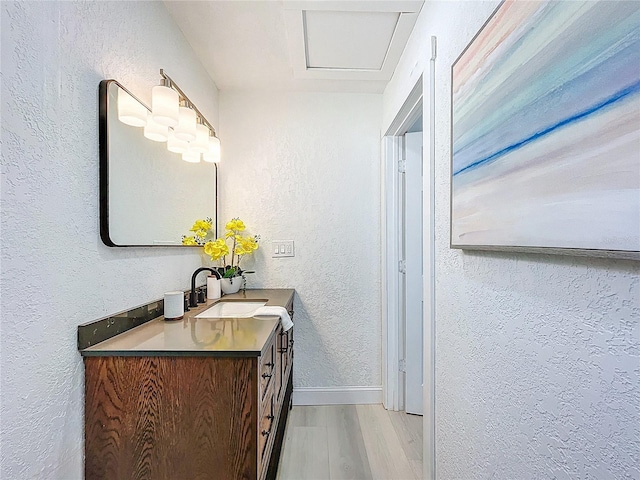 2711 W Cordelia St, Tampa, FL 33607 - bathroom with wood finished floors, a textured wall, baseboards, and vanity