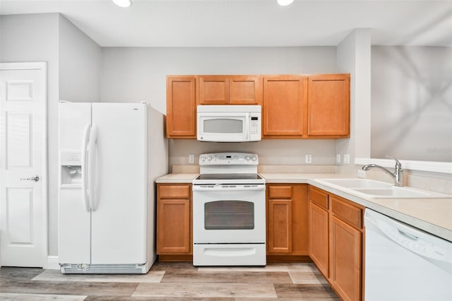 10407 Westpark Preserve Blvd, Tampa, FL 33625 - kitchen featuring white appliances, a sink, recessed lighting, light wood-type flooring, and light countertops