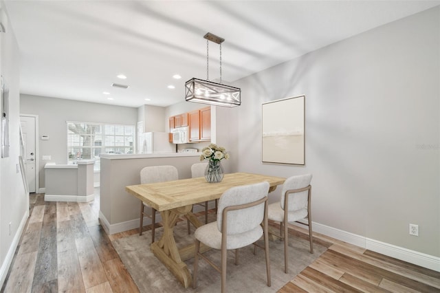 10407 Westpark Preserve Blvd, Tampa, FL 33625 - dining space with light wood finished floors, baseboards, recessed lighting, and a chandelier
