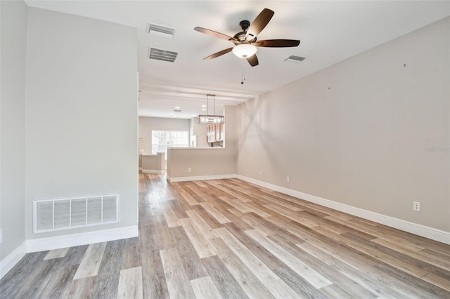 10407 Westpark Preserve Blvd, Tampa, FL 33625 - spare room with a ceiling fan, light wood-type flooring, baseboards, and a chandelier