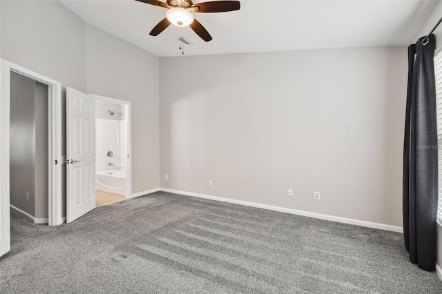 10407 Westpark Preserve Blvd, Tampa, FL 33625 - unfurnished bedroom with carpet, baseboards, ensuite bathroom, vaulted ceiling, and a ceiling fan