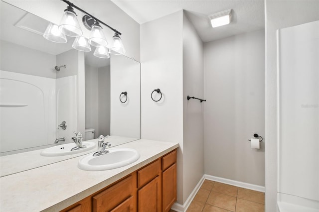10407 Westpark Preserve Blvd, Tampa, FL 33625 - bathroom with tile patterned floors, a shower, vanity, toilet, and baseboards