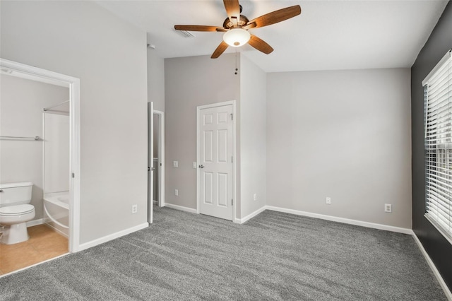 10407 Westpark Preserve Blvd, Tampa, FL 33625 - unfurnished bedroom with carpet, vaulted ceiling, baseboards, and ensuite bath