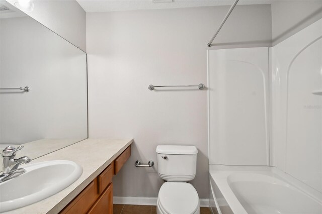 10407 Westpark Preserve Blvd, Tampa, FL 33625 - full bathroom with toilet, vanity, washtub / shower combination, baseboards, and tile patterned floors