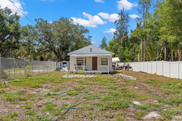 rear view of property with a fenced backyard