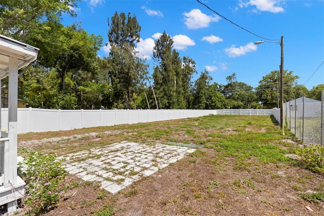 view of yard with a fenced backyard and a patio
