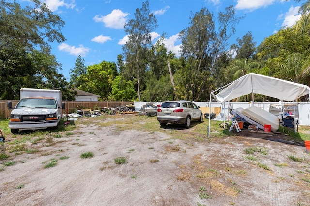view of parking with fence