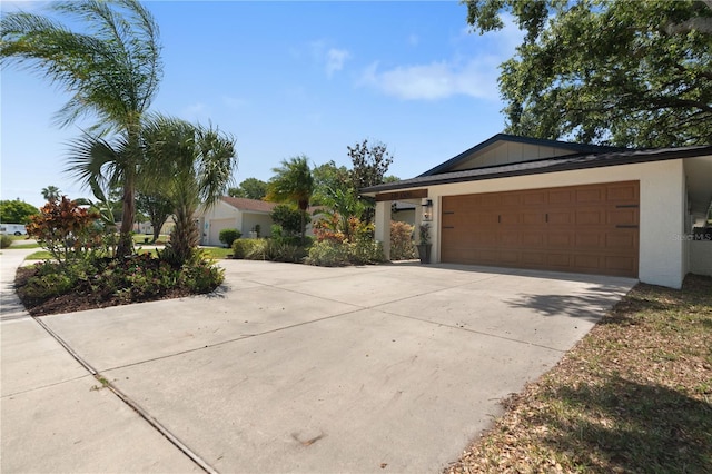 ranch-style house with stucco siding, driveway, and a garage