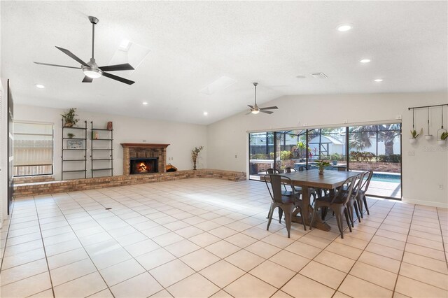 dining area featuring a brick fireplace, recessed lighting, ceiling fan, and lofted ceiling