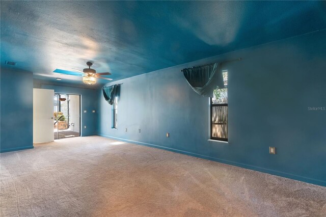empty room with baseboards, carpet, and a ceiling fan