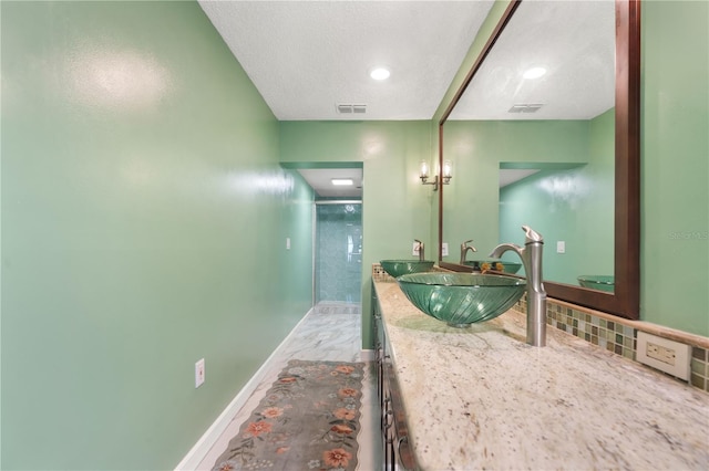 full bathroom featuring baseboards, visible vents, a shower stall, and vanity