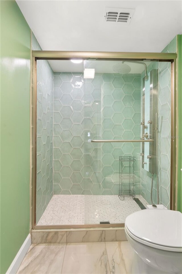 full bathroom with a shower stall and visible vents