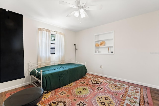bedroom with baseboards, a ceiling fan, and wood finished floors