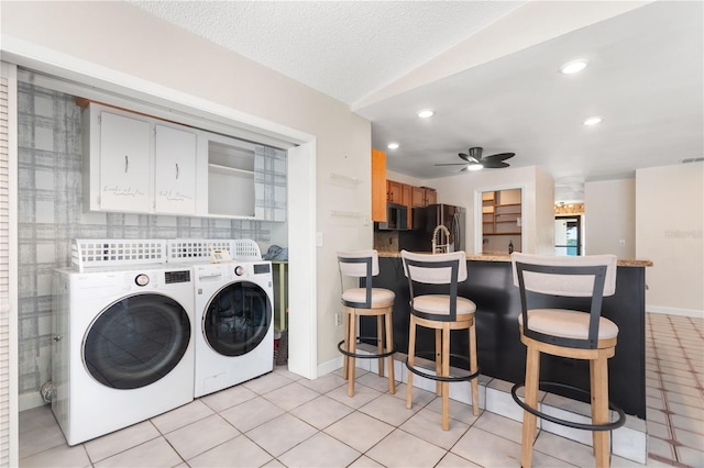 laundry room featuring ceiling fan, laundry area, baseboards, light tile patterned flooring, and washer and dryer