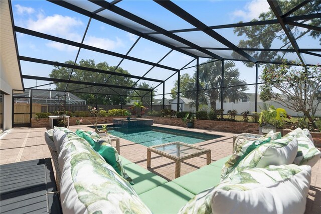 view of pool with a patio, a pool with connected hot tub, an outdoor living space, and a lanai