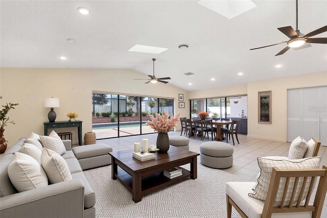1509 Coachlight Way, Dunedin, FL 34698 - living room featuring a skylight, vaulted ceiling, a ceiling fan, recessed lighting, and light tile patterned floors
