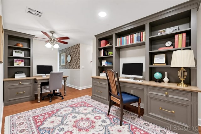 1509 Coachlight Way, Dunedin, FL 34698 - office with a ceiling fan, built in desk, baseboards, wood finished floors, and recessed lighting
