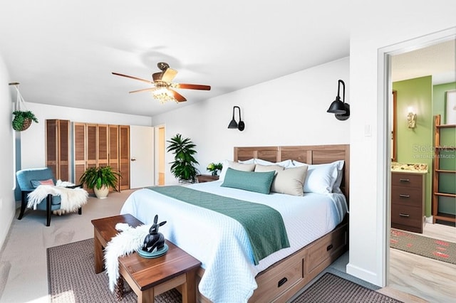 1509 Coachlight Way, Dunedin, FL 34698 - carpeted bedroom featuring a ceiling fan and connected bathroom
