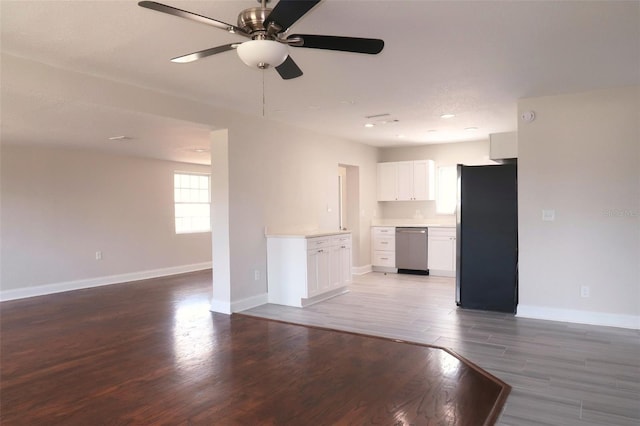 unfurnished living room with wood finished floors, ceiling fan, and baseboards