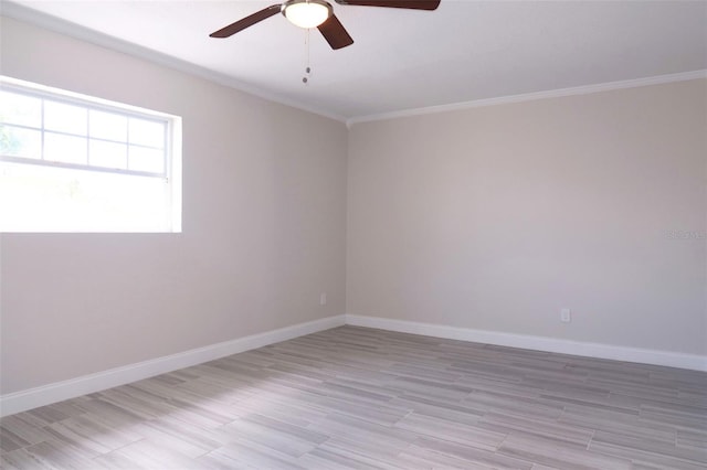 empty room featuring light wood-style floors, baseboards, crown molding, and a ceiling fan
